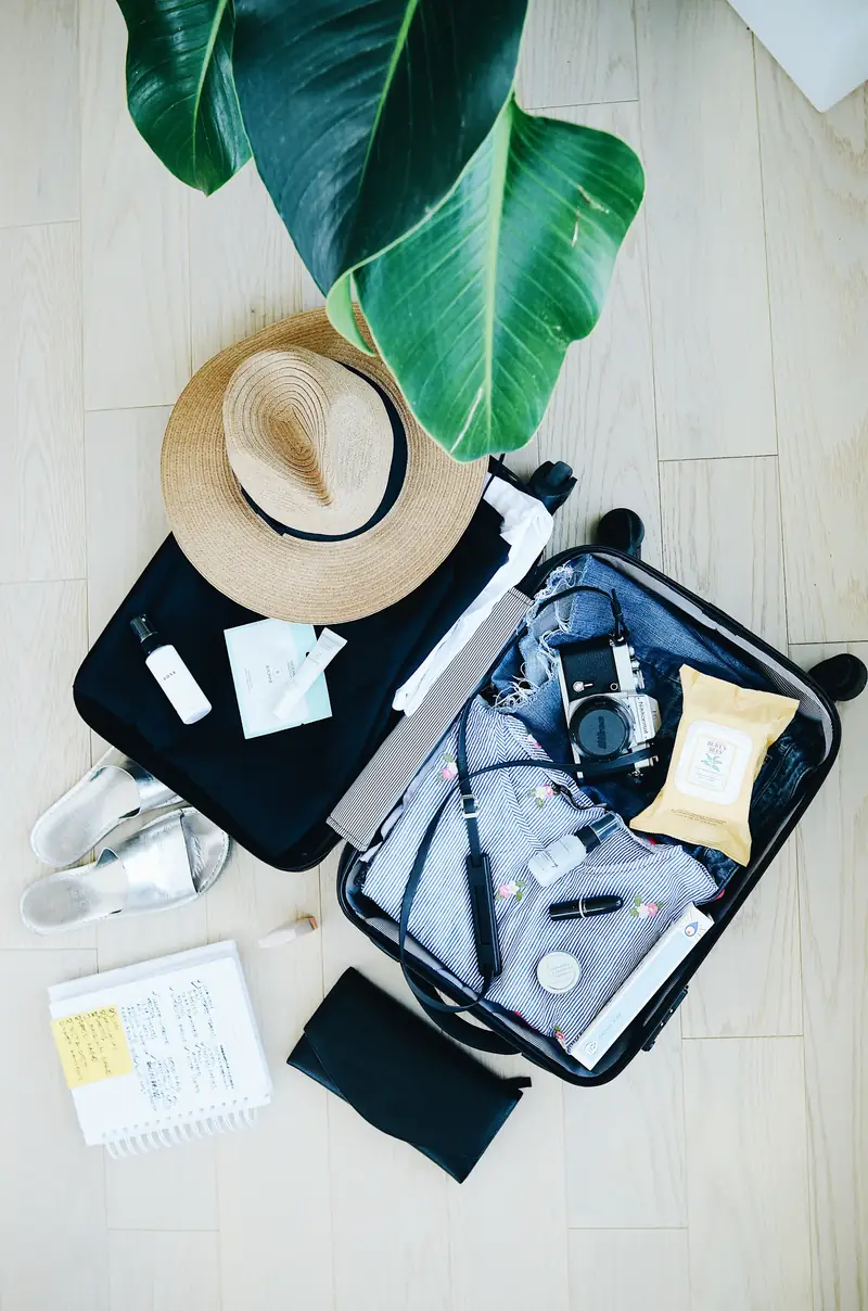 Mala aberta com itens de viagem